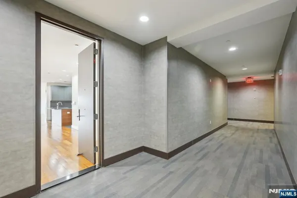 an empty room with wooden floor and door