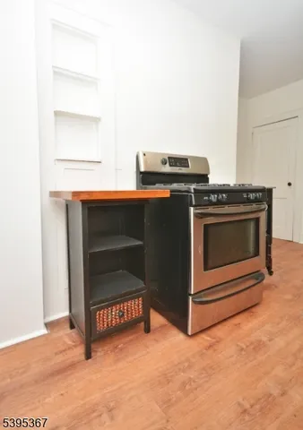 a view of an empty room with a fireplace and a window
