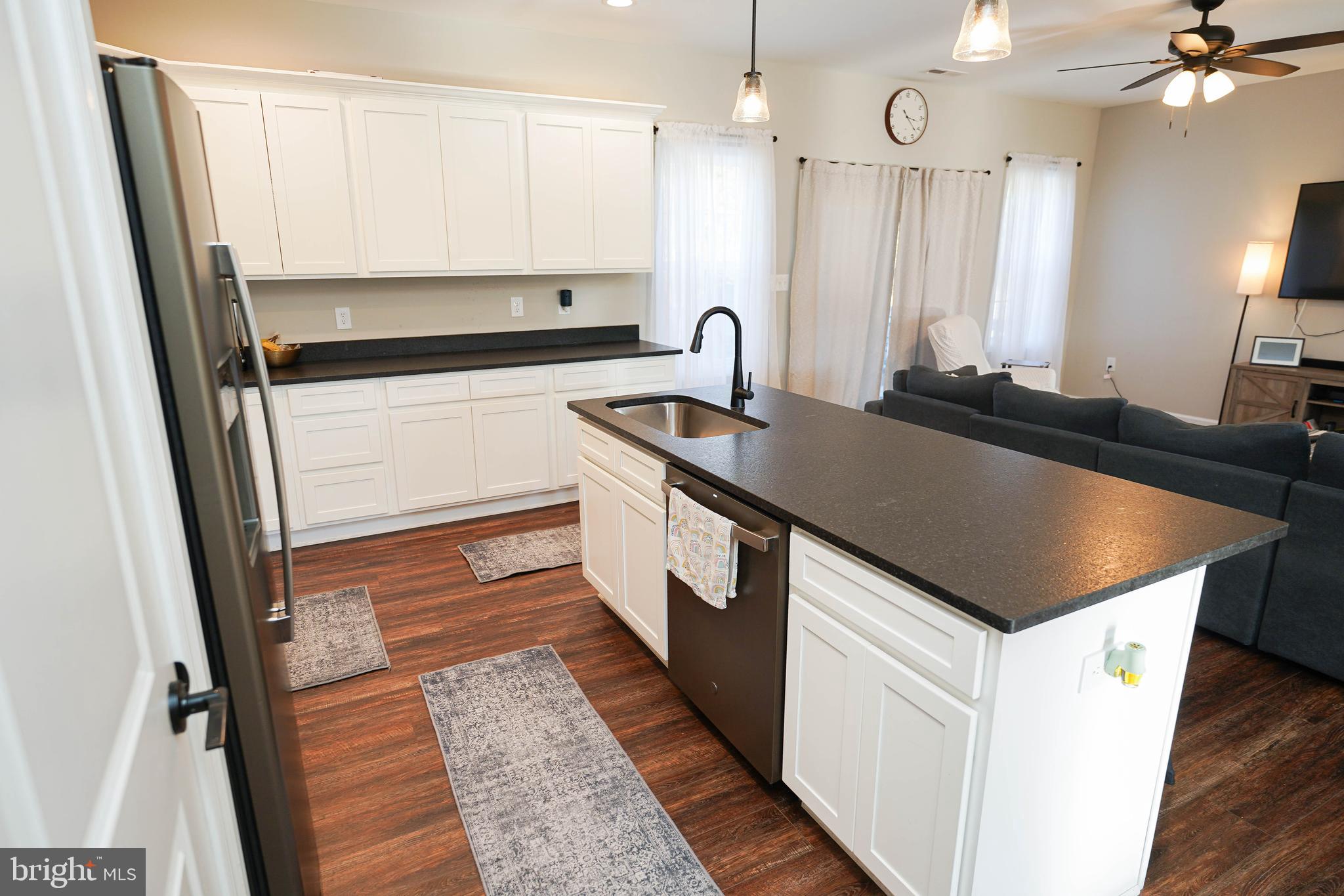2054 Groton Road Pocomoke City, MD 21851 - Photo 12 of 42 a kitchen with granite countertop a sink and cabinets