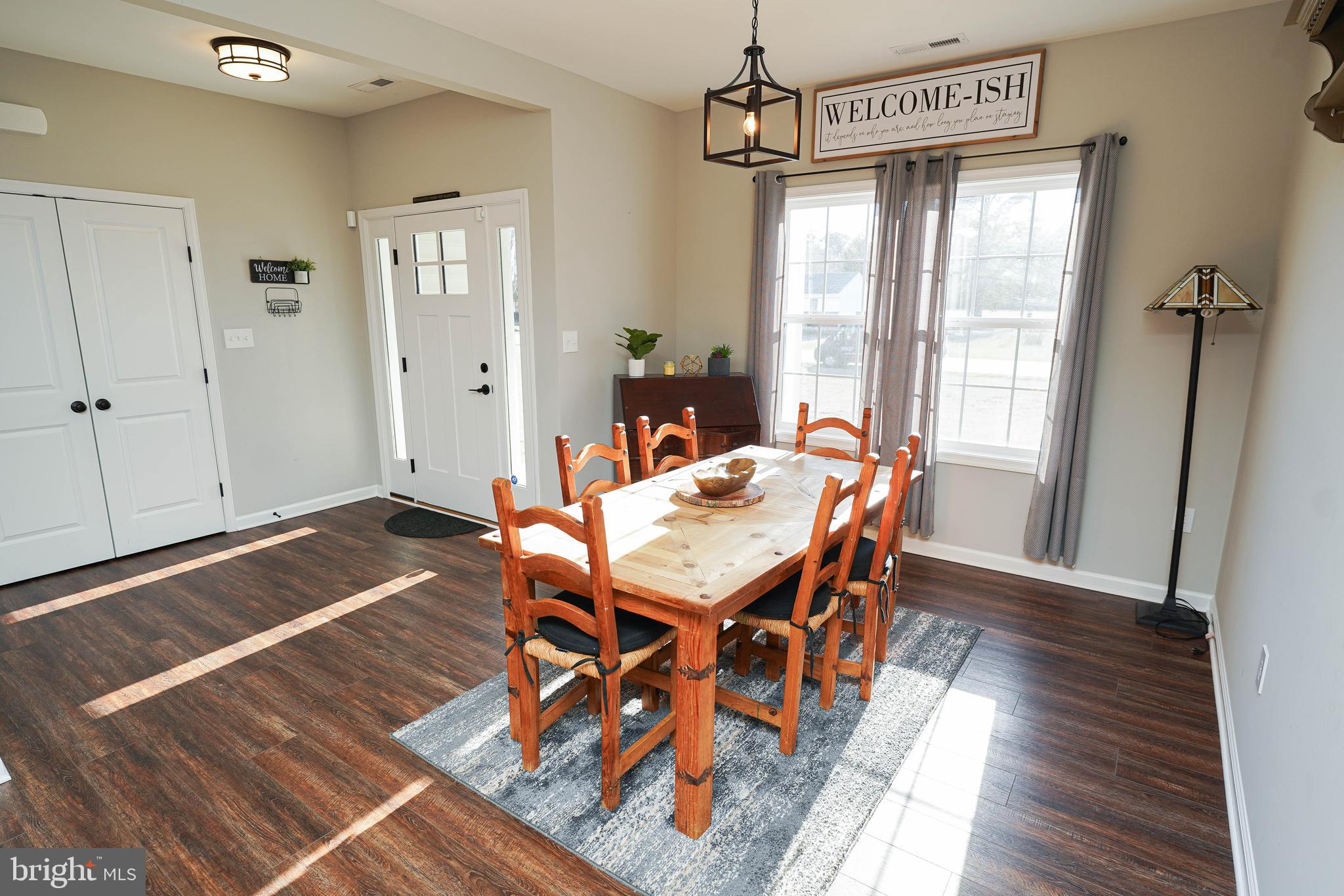 2054 Groton Road Pocomoke City, MD 21851 - Photo 13 of 42 a dining room with wooden floor a chandelier a wooden table and chairs