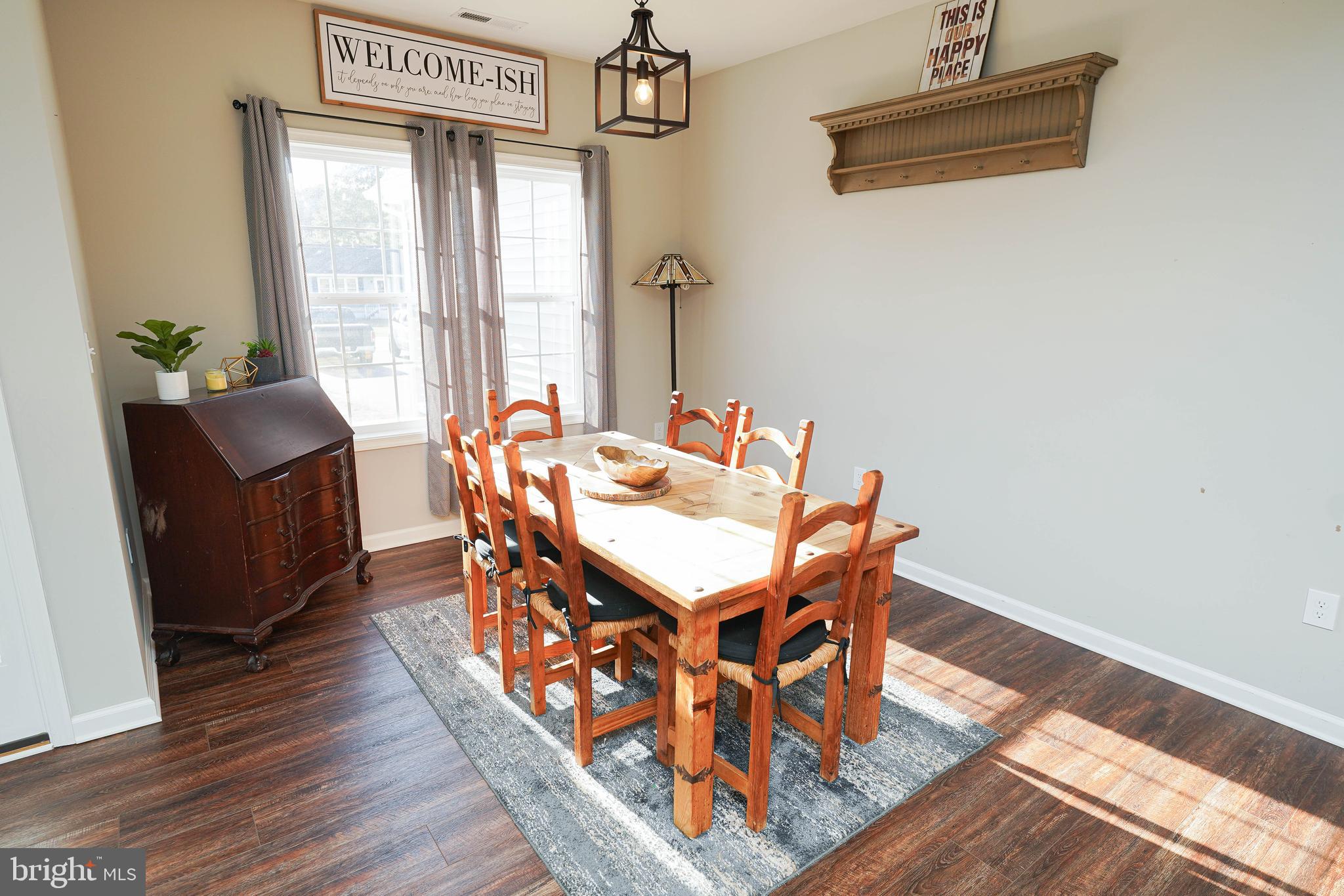 2054 Groton Road Pocomoke City, MD 21851 - Photo 14 of 42 a dining room with furniture a chandelier and wooden floor