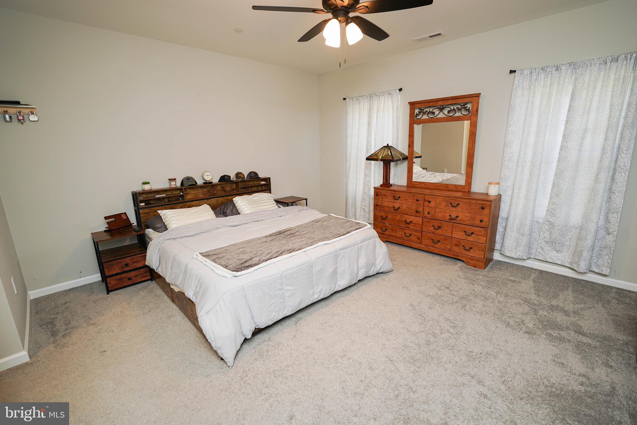 2054 Groton Road Pocomoke City, MD 21851 - Photo 16 of 42 a bedroom with a bed and a chandelier