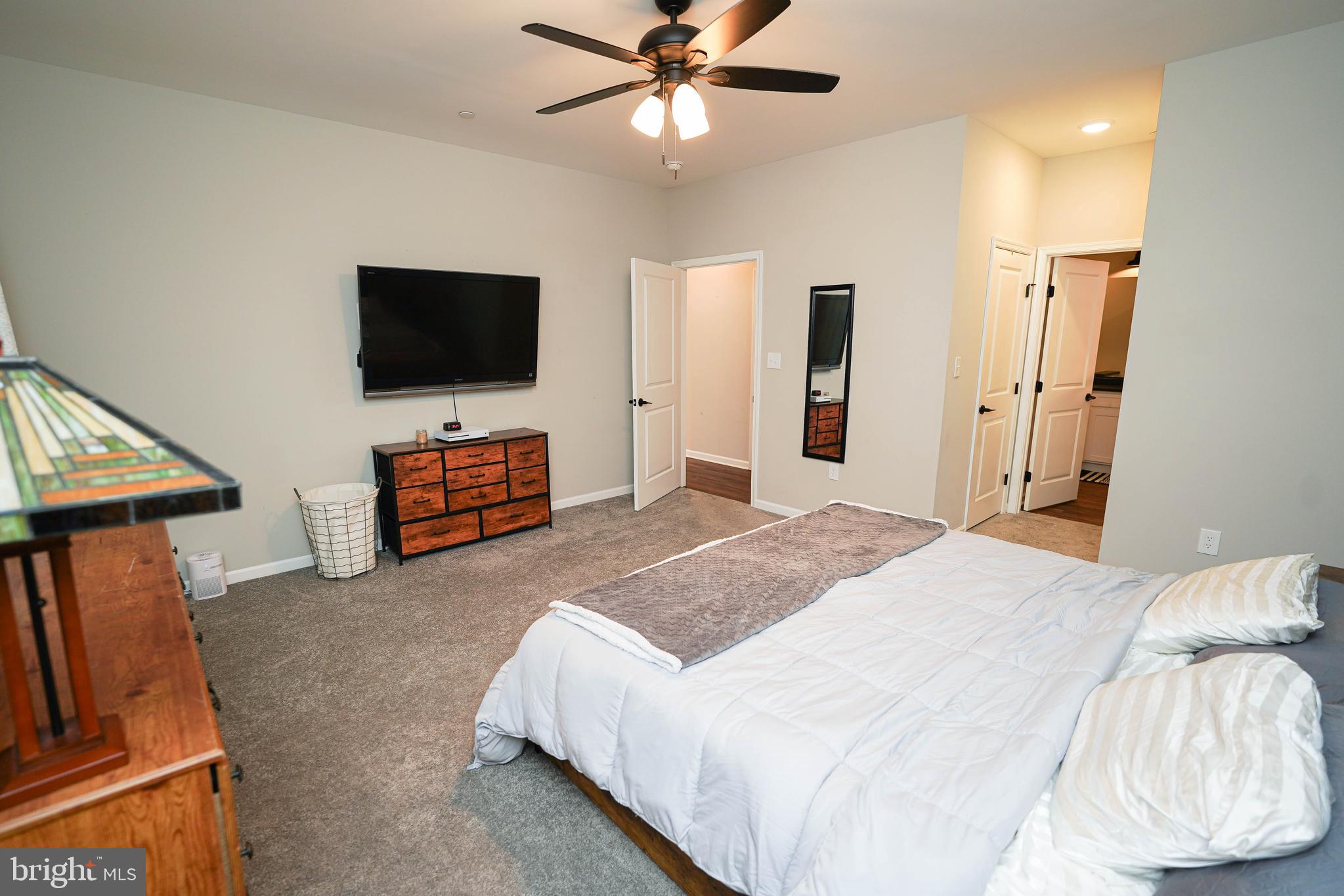 2054 Groton Road Pocomoke City, MD 21851 - Photo 18 of 42 a spacious bedroom with a bed and a flat screen tv