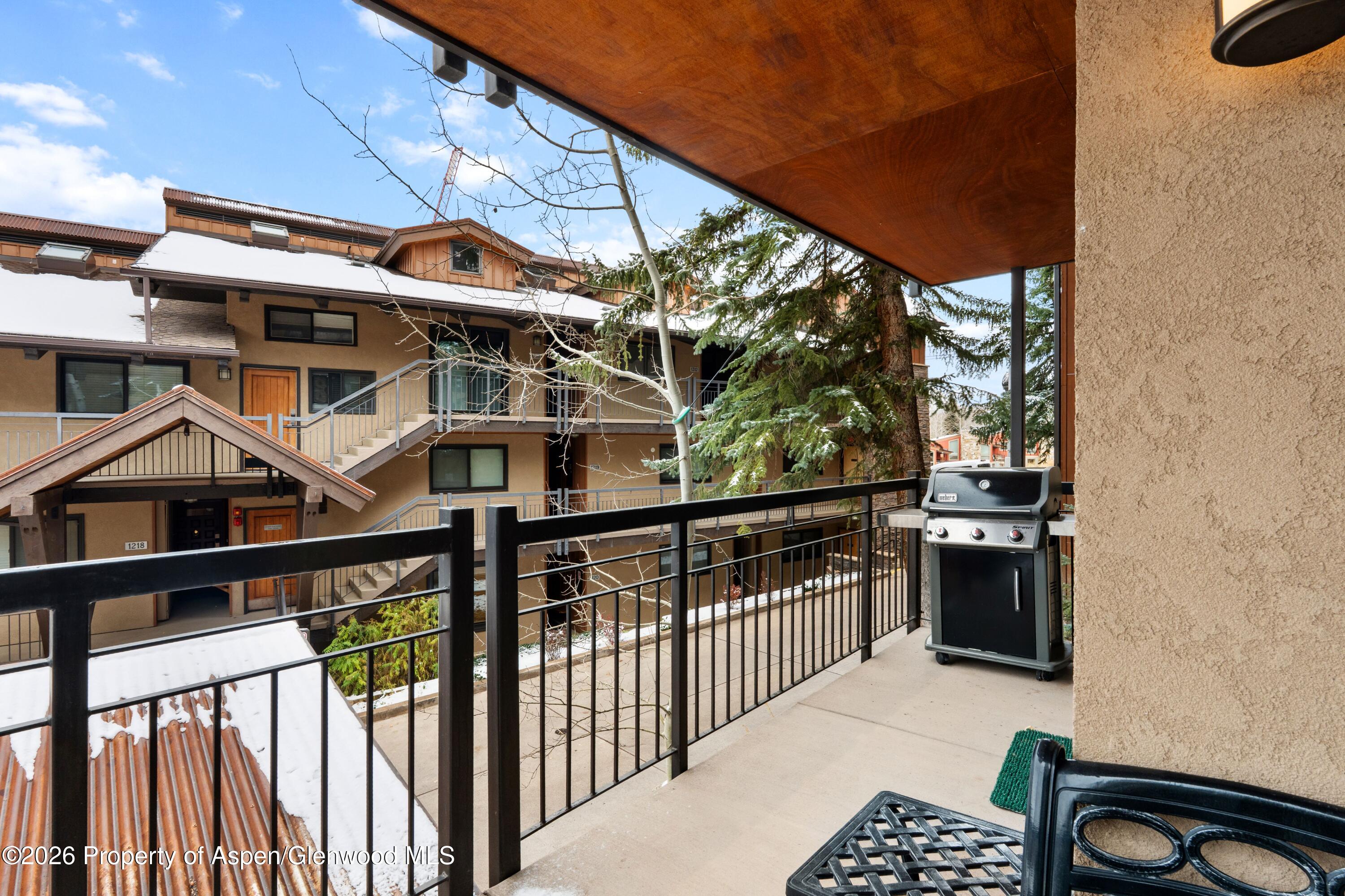 400 Wood Road, Unit 2111H Snowmass Village, CO 81615 - Photo 14 of 16 a view of a house with wooden fence