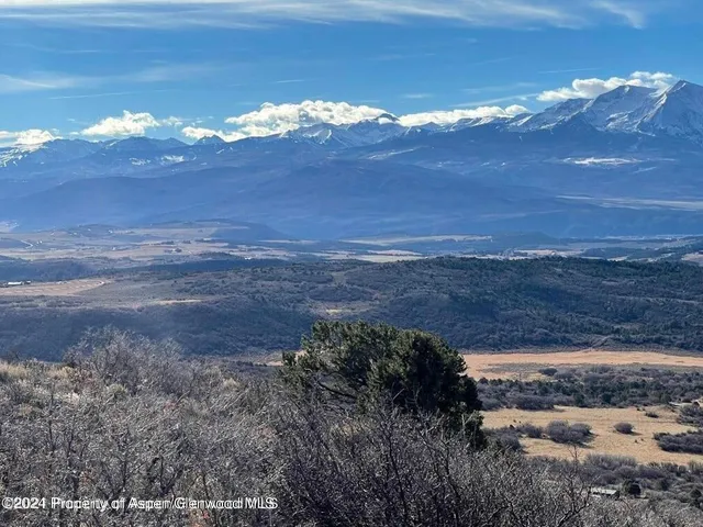 a kitchen with stainless steel appliances kitchen island granite countertop a stove and a refrigerator