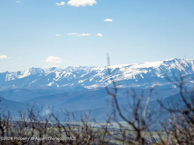 a view of a yard with mountains in the background
