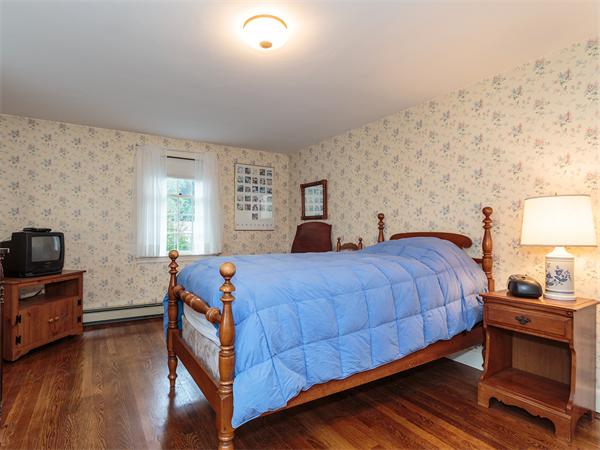 4 Robinhood Road Winchester, MA 01890 - Photo 13 of 26 a bedroom with bed table and window