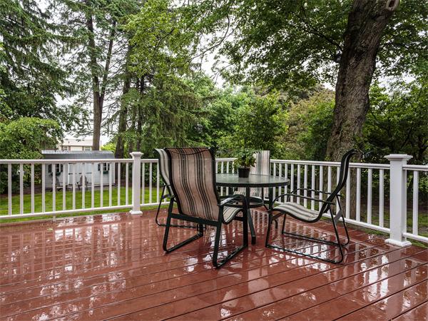 4 Robinhood Road Winchester, MA 01890 - Photo 20 of 26 a view of a chair and table on the wooden deck