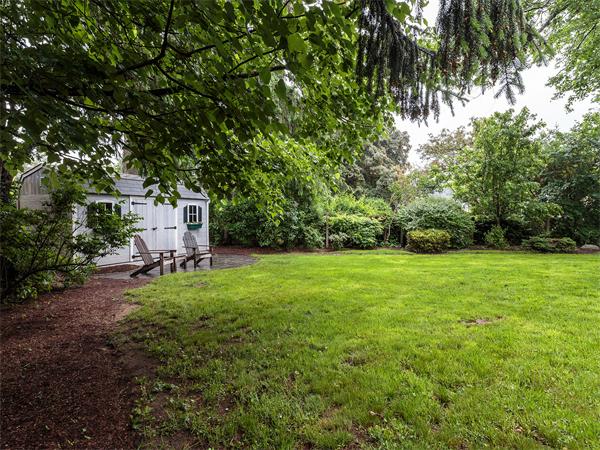4 Robinhood Road Winchester, MA 01890 - Photo 22 of 26 a view of a backyard with table and chairs and wooden fence