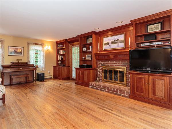 4 Robinhood Road Winchester, MA 01890 - Photo 6 of 26 a living room with furniture a flat screen tv and kitchen view