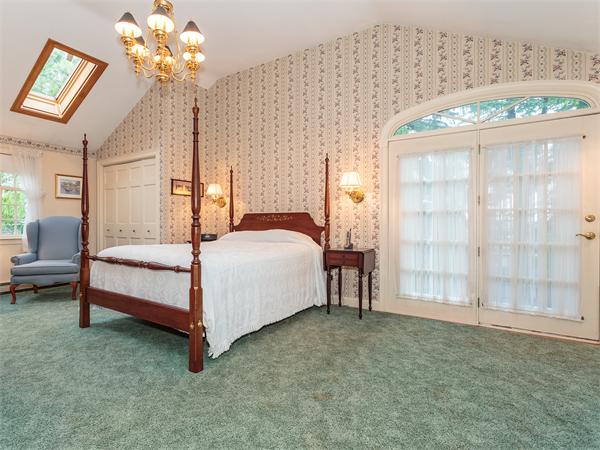 4 Robinhood Road Winchester, MA 01890 - Photo 10 of 26 a bedroom with a bed table and window