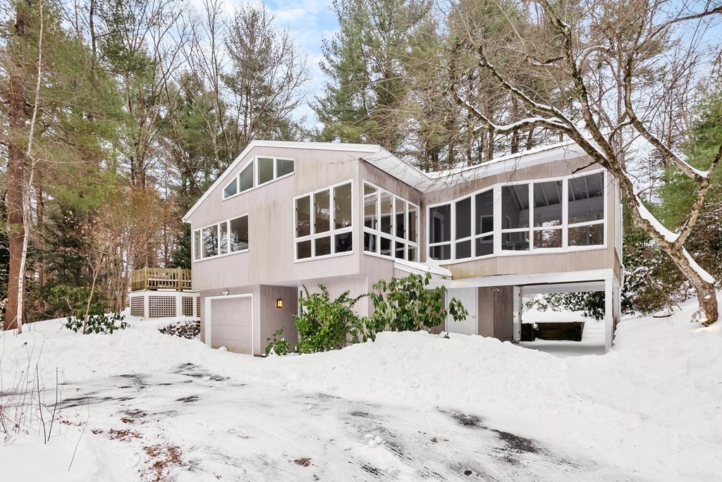 9 Valley View Road Weston, MA 02493 - Photo 1 of 30 a front view of a house with a yard covered with snow