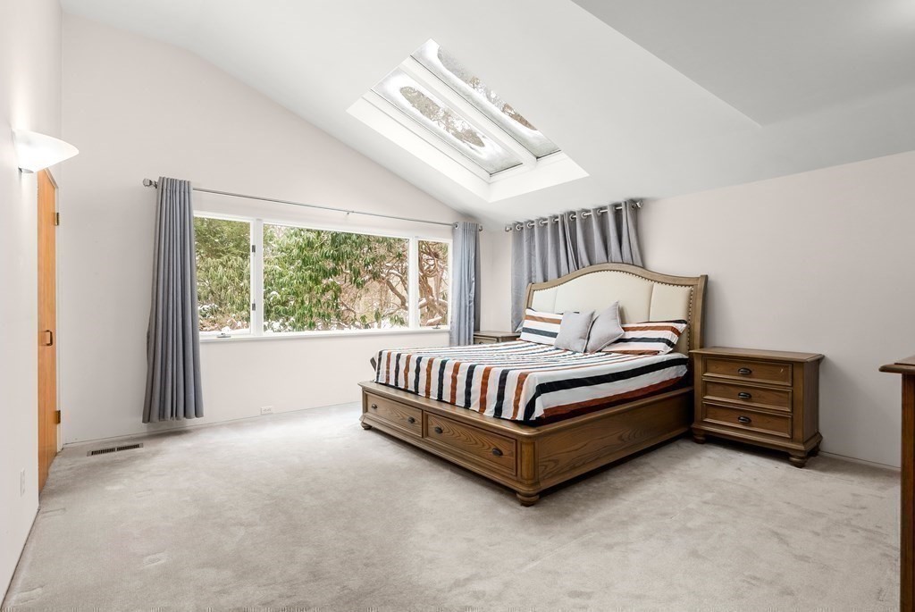 9 Valley View Road Weston, MA 02493 - Photo 13 of 30 a spacious bedroom with a bed and a large window