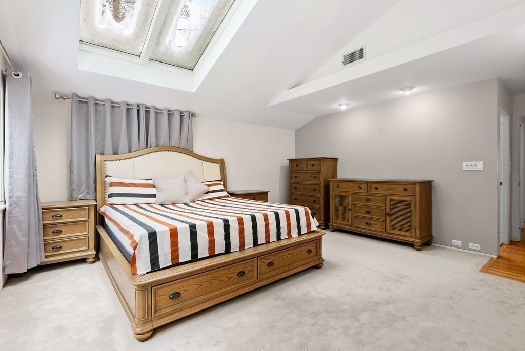 9 Valley View Road Weston, MA 02493 - Photo 15 of 30 a spacious bedroom with a bed and a couch