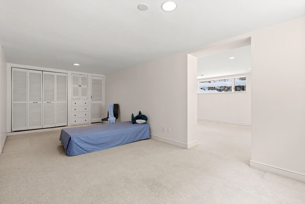 9 Valley View Road Weston, MA 02493 - Photo 23 of 30 a spacious bedroom with a bed and a cabinet