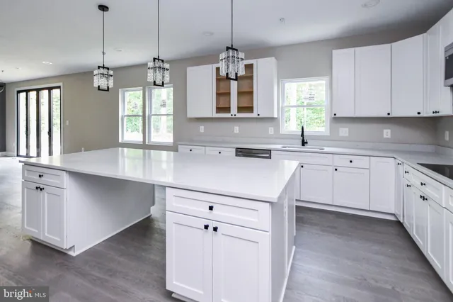 a kitchen with granite countertop a sink and a stove top oven