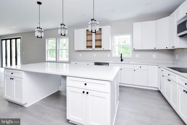 a kitchen with stainless steel appliances granite countertop a stove sink and microwave