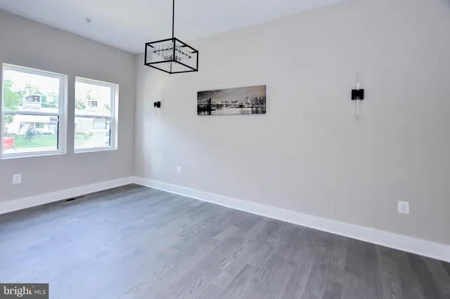 a view of a room with wooden floor and window