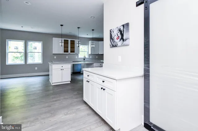 an empty room with windows and closet