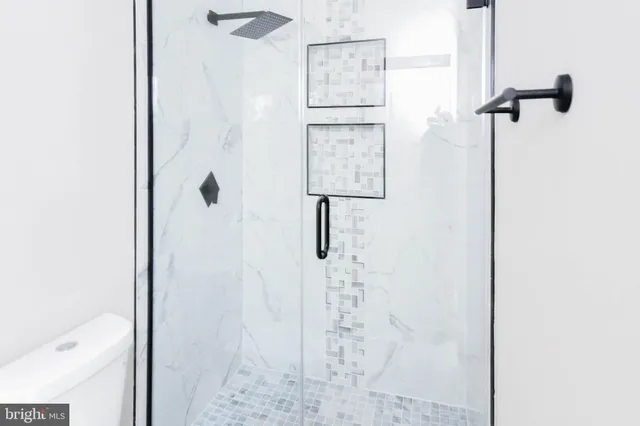 an empty room with closet and natural light