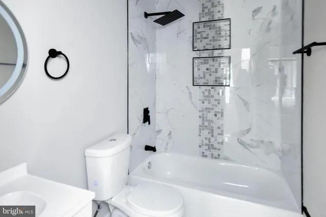 a view of a house with a yard and a large tree