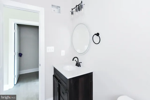 a view of a livingroom with a ceiling fan and window