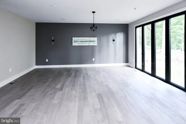 a kitchen with stainless steel appliances granite countertop a stove a sink and white cabinets