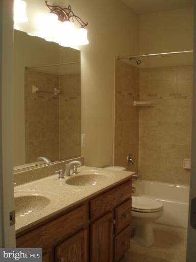 3 Elmer Derr Road Frederick, MD 21703 - Photo 11 of 30 a bathroom with a granite countertop sink toilet and shower