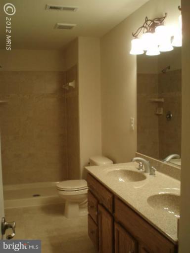 3 Elmer Derr Road Frederick, MD 21703 - Photo 23 of 30 a bathroom with a granite countertop sink toilet and shower