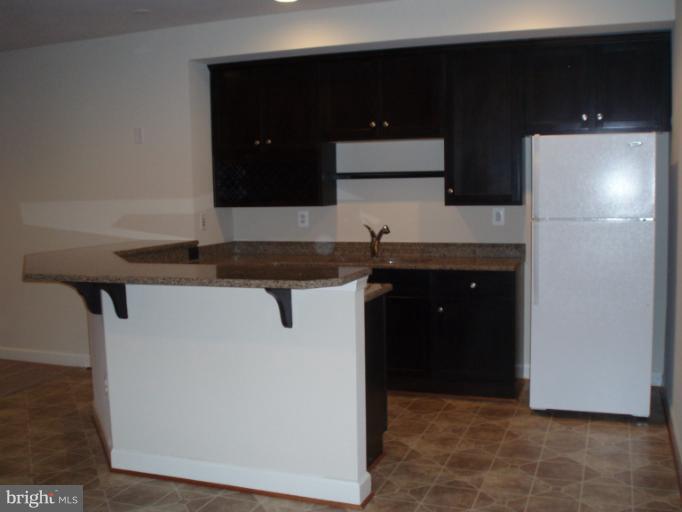 3 Elmer Derr Road Frederick, MD 21703 - Photo 26 of 30 a kitchen with a sink and a refrigerator
