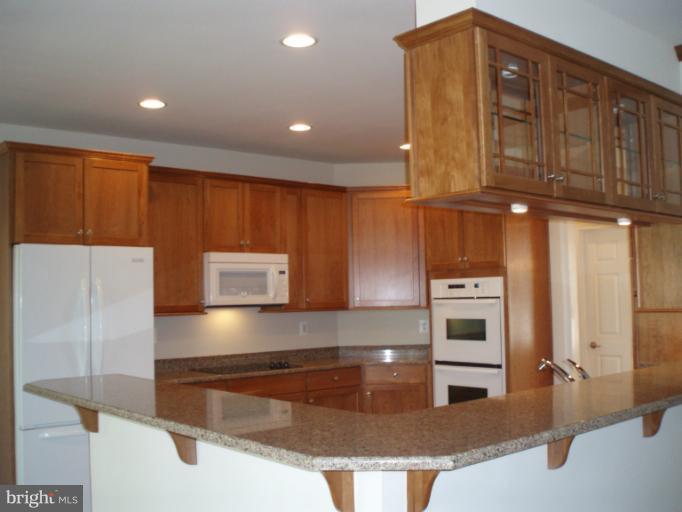 3 Elmer Derr Road Frederick, MD 21703 - Photo 4 of 30 a kitchen with stainless steel appliances granite countertop a refrigerator and a stove