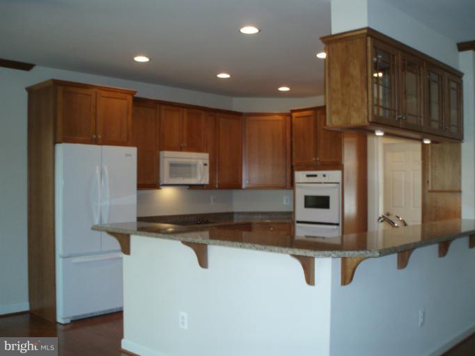 3 Elmer Derr Road Frederick, MD 21703 - Photo 6 of 30 a kitchen with stainless steel appliances a refrigerator and a stove top oven