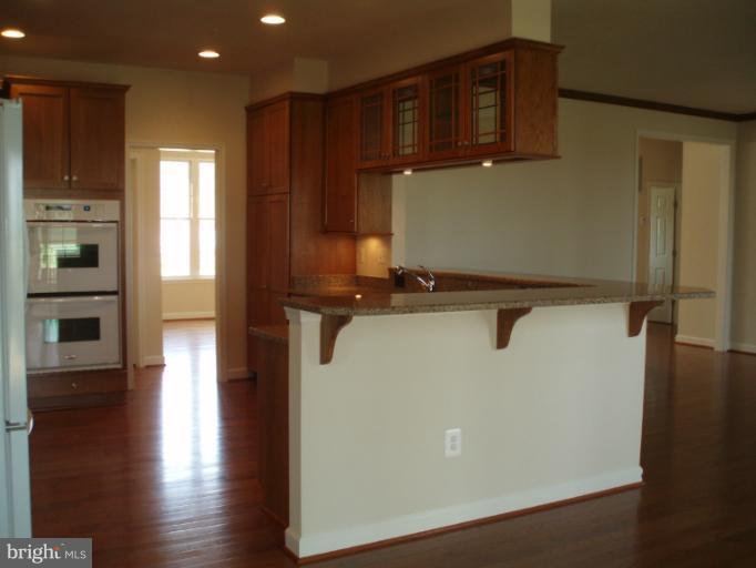 3 Elmer Derr Road Frederick, MD 21703 - Photo 7 of 30 a view of a refrigerator in kitchen and wooden floor