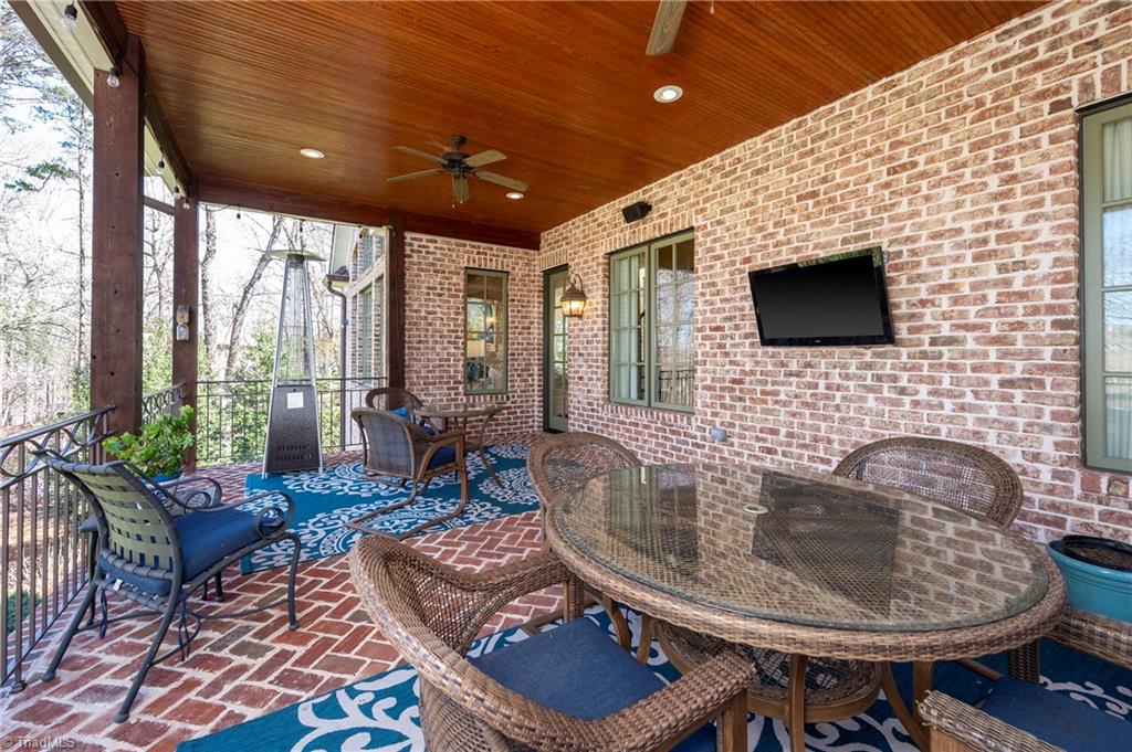 287 James Way Bermuda Run, NC 27006 - Photo 39 of 44 Cover patio with brick flooring, stained tongue and groove ceiling with views of pond and pond wildlife