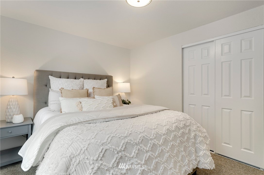 17307 18th Avenue Southeast Bothell, WA 98012 - Photo 11 of 40 a large bed sitting in a bedroom next to a window