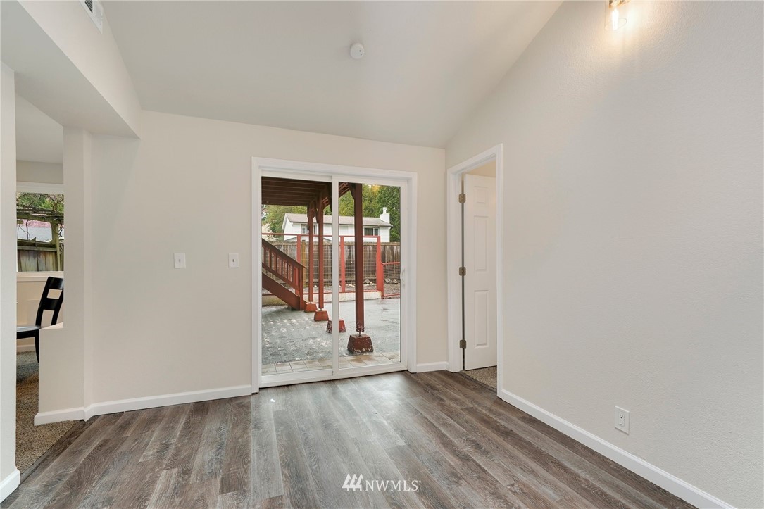 17307 18th Avenue Southeast Bothell, WA 98012 - Photo 22 of 40 an empty room with wooden floor and entrance