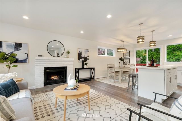 a living room with furniture a clock and a fireplace