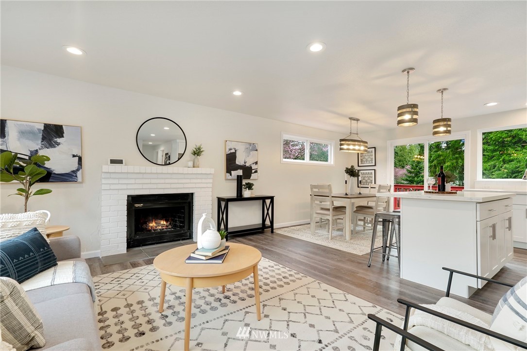 17307 18th Avenue Southeast Bothell, WA 98012 - Photo 4 of 40 a living room with furniture a clock and a fireplace