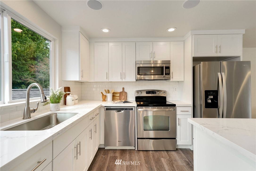 17307 18th Avenue Southeast Bothell, WA 98012 - Photo 9 of 40 a kitchen with stainless steel appliances granite countertop a refrigerator sink and stove
