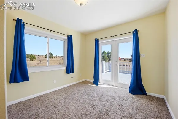a bedroom with a large bed and a large window