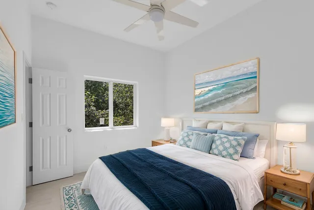 a bedroom with a bed and a painting on the wall