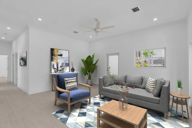 a living room with furniture and a potted plant