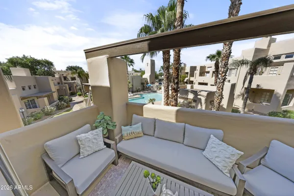 a balcony with furniture and a potted plant