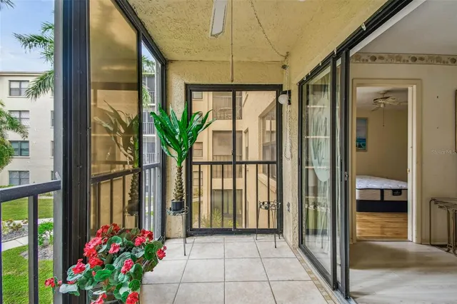 a view of a hallway with furniture and a ceiling fan
