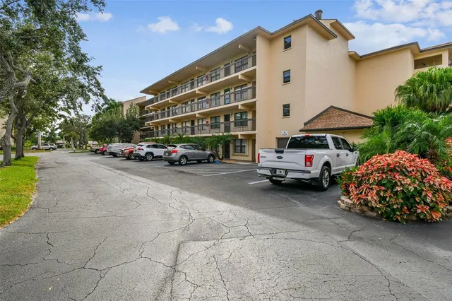 a car parked in front of a white building