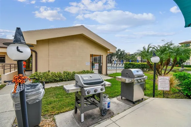 a view of a house with a yard and sitting area