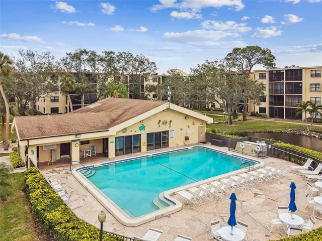 a front view of a house with a yard and potted plants