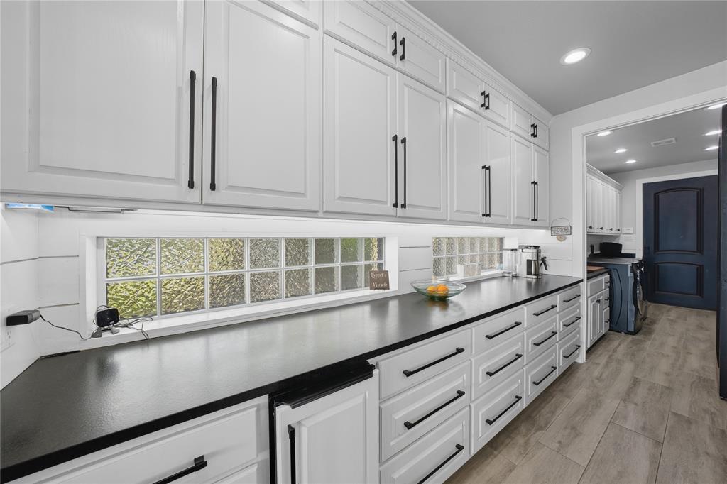 1617 Maple Drive Tool, TX 75143 - Photo 11 of 40 a kitchen with granite countertop white cabinets and window