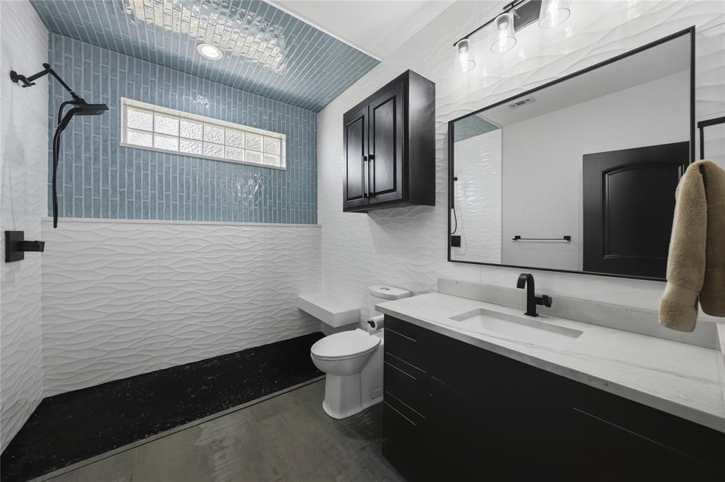 1617 Maple Drive Tool, TX 75143 - Photo 21 of 40 a bathroom with a sink toilet and mirror