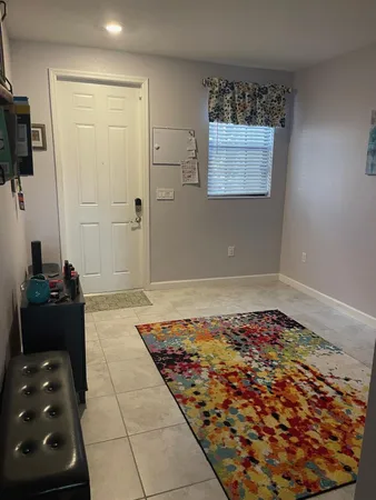 a living room with furniture and a rug